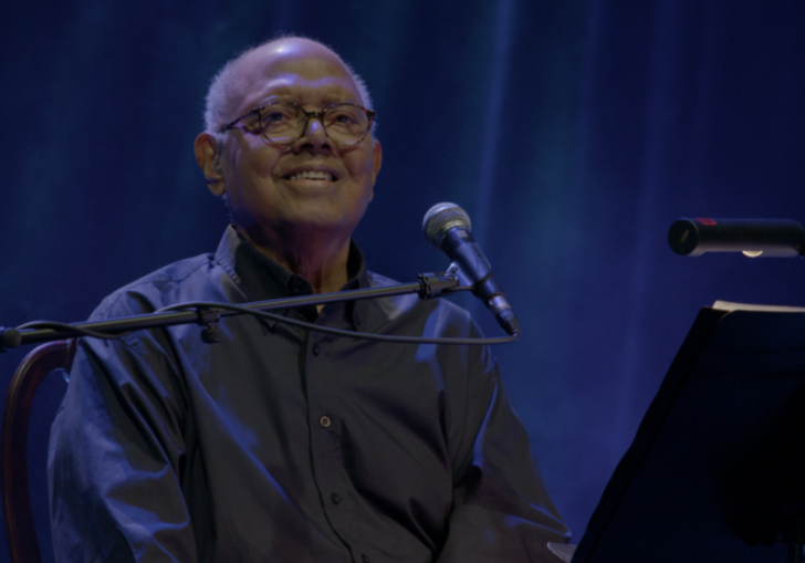 A man in front a mic