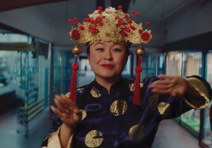 A Vietnamese woman dances in a hallway