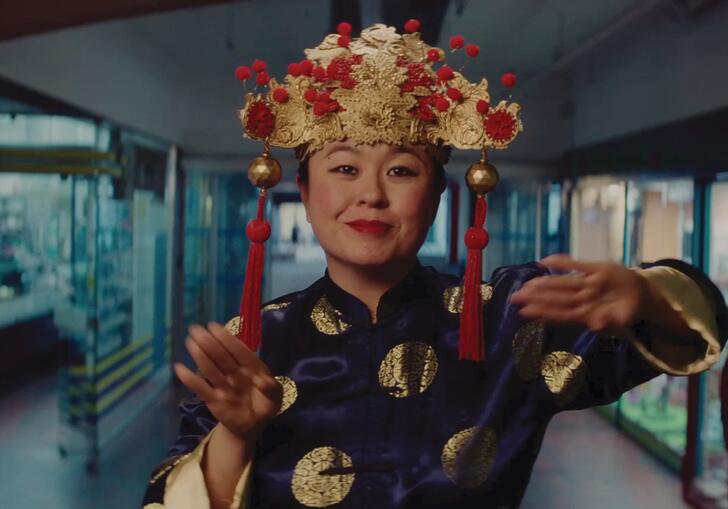 A Vietnamese woman dances in a hallway