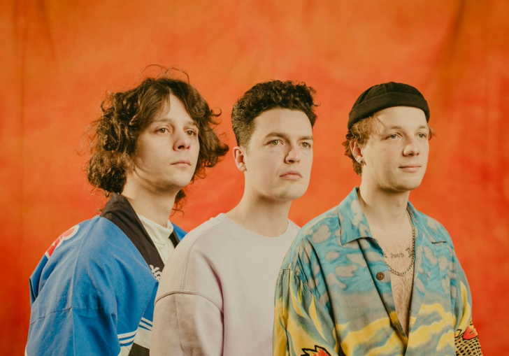 An image of the band Immortal Onion in front of an orange background