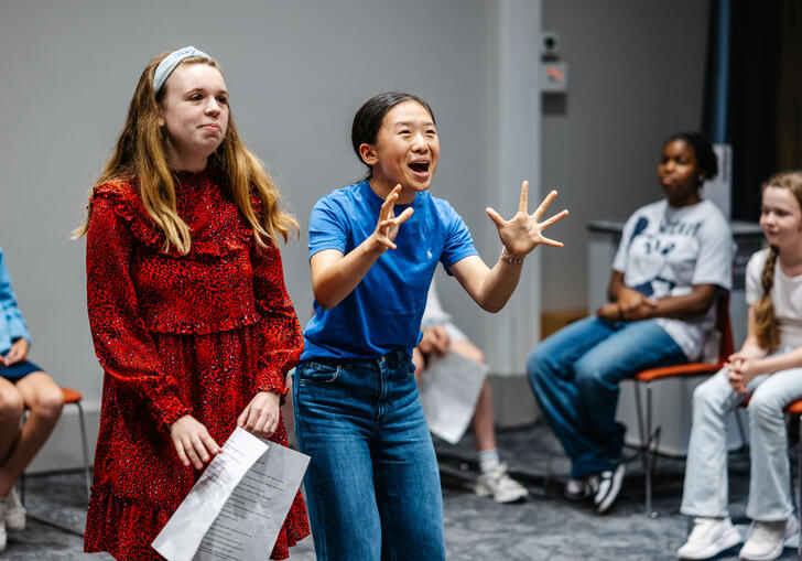 A group of young people performing in a drama workshop