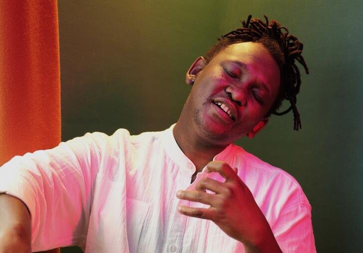 Abel looking wistful playing an air cello 