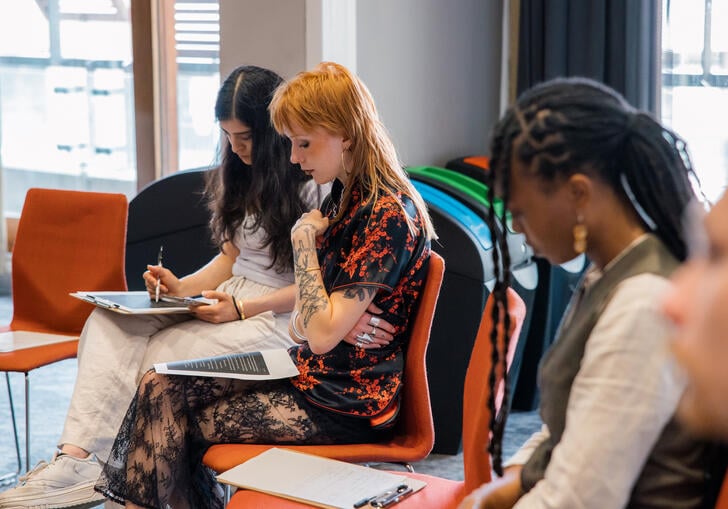 A group of young people at a writing workshop