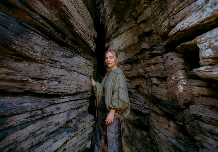Laura Misch stood in front of a stone background