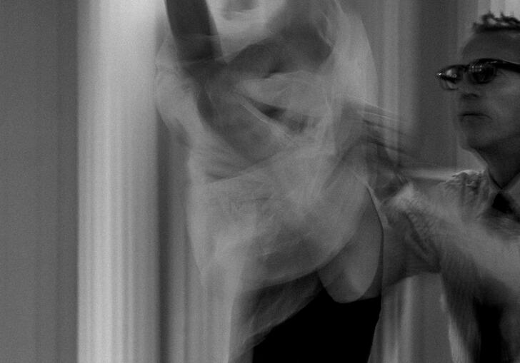 Olivier Sallaird dresses a model in a wedding dr4ess