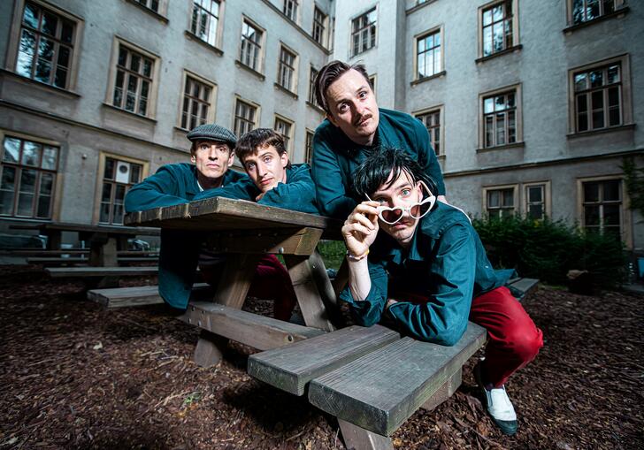 An image of Synesthetic 4tet  sitting on a park bench with a fish eye effect