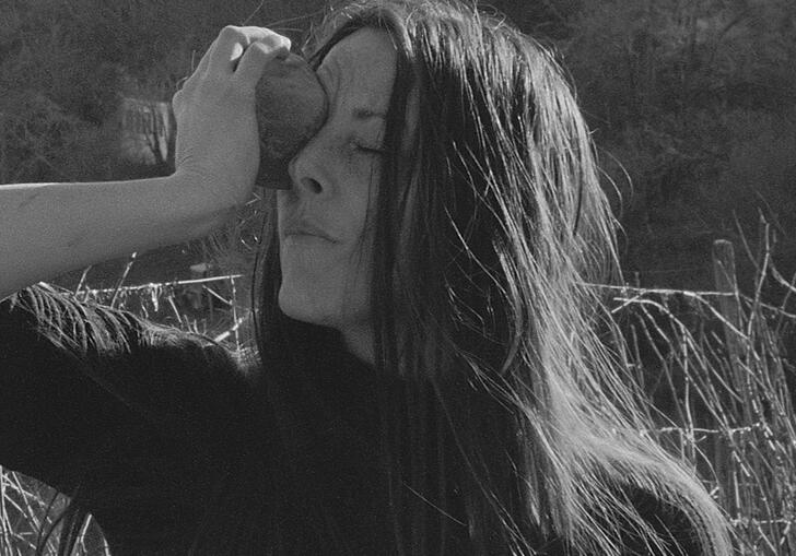 A woman holding something to her face