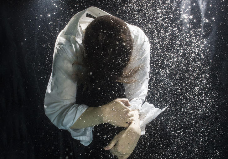 Photo of a figure floating under water