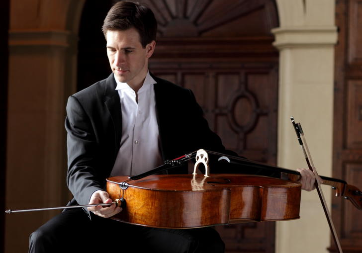 A picture of Guy Johnson holding a cello