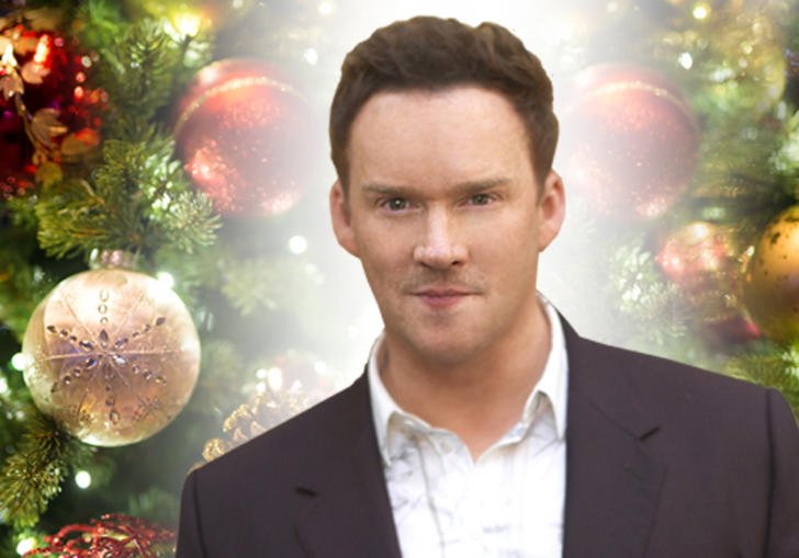 Image of Russell Watson against a backdrop of Christmas decorations