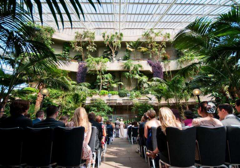A photo of a wedding ceremony in the Barbican Conservatory