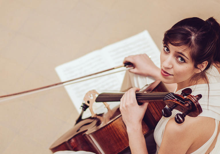 Photo of Thomas with violin and sheet music