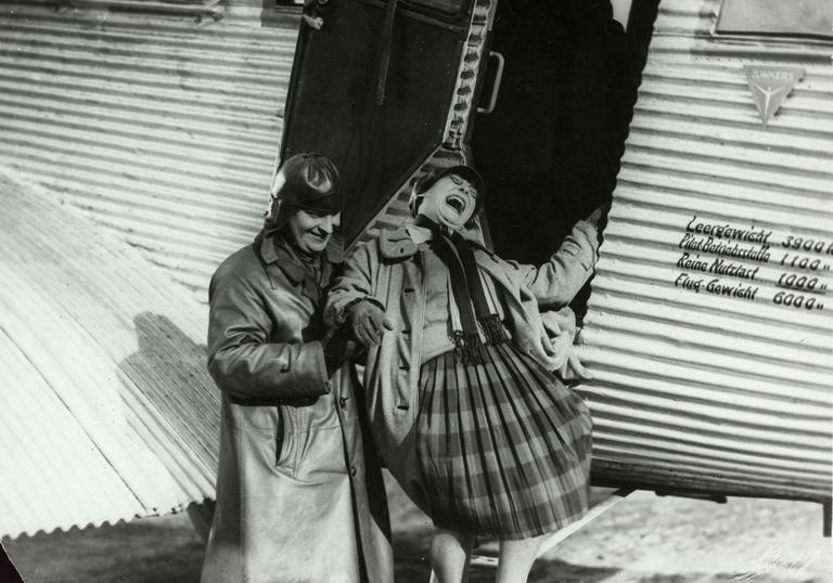 A. Rodchenko and V. Stepanova descending from an airplane. 