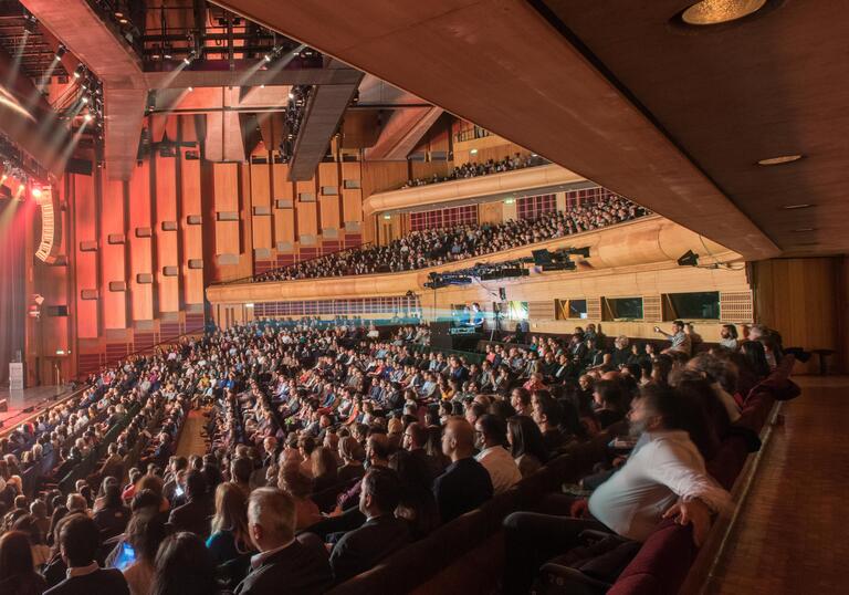 Photo of music performance and a full audience in the Barbican Hall