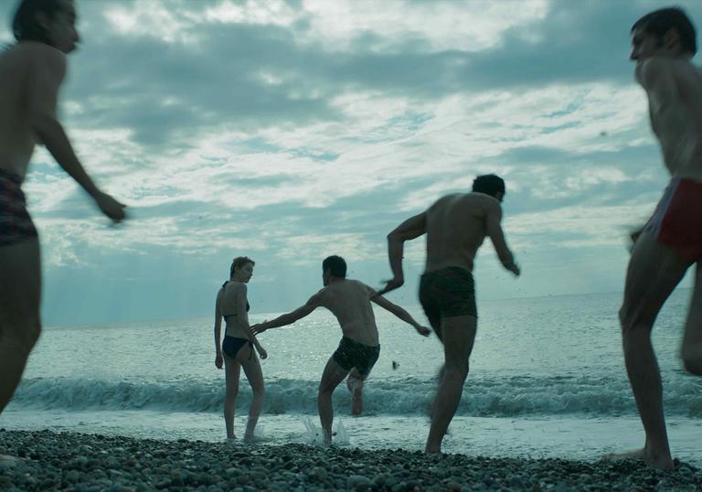 Photo of people running into the sea