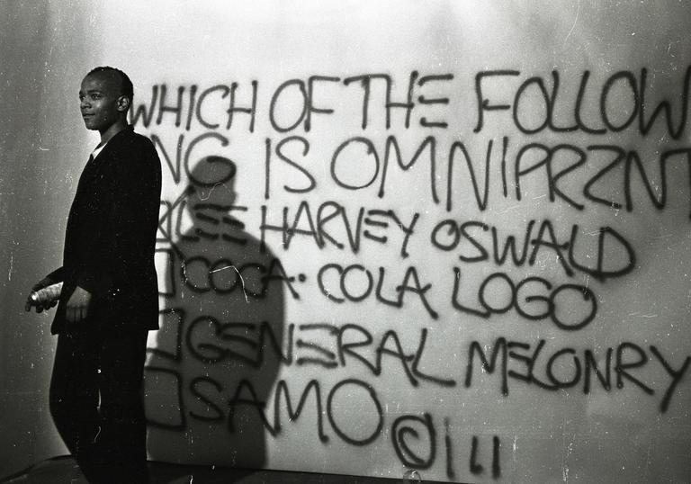 Photo of Basquiat with graffiti