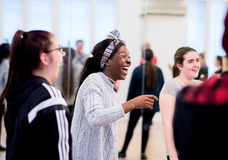Photo of group of young people laughing in a workshop