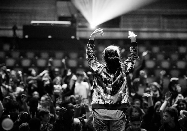 Photo of woman performing on stage in front of an audience