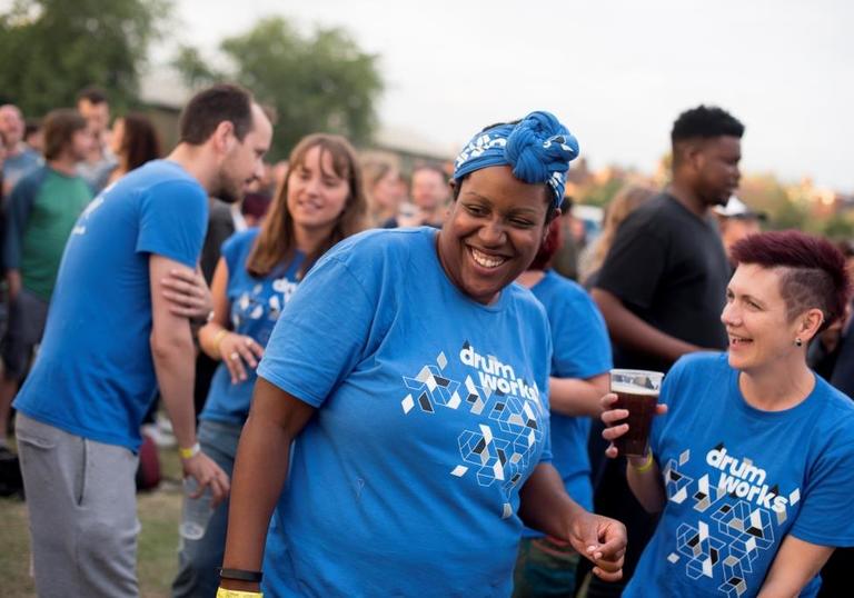 Photo of people from Drum Works laughing at Walthamstow Garden Party