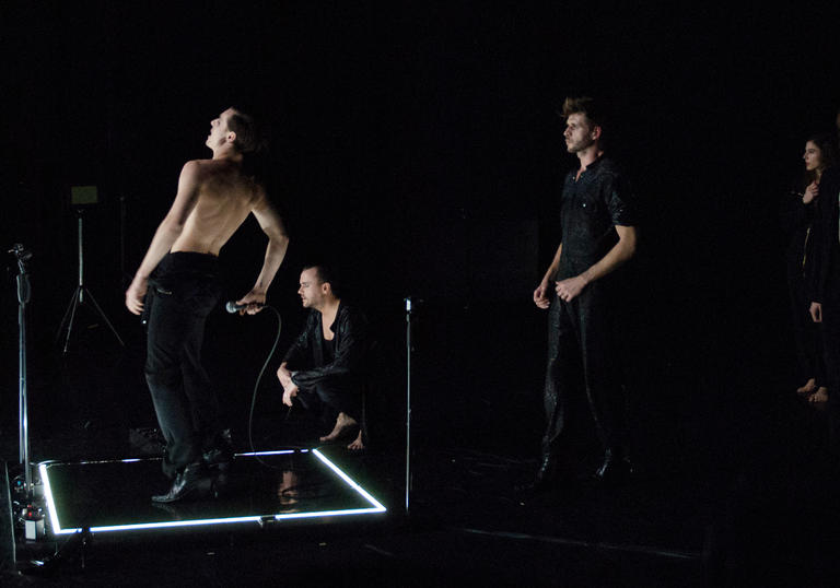 photo of dancers in a dark room