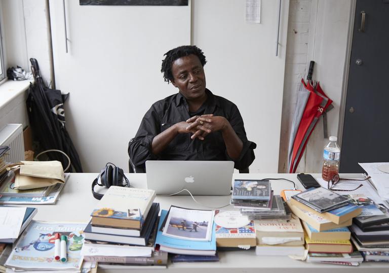 Photo of artist John Akomfrah in his studio