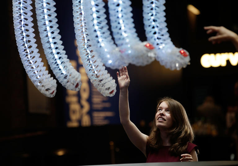 photo of a woman touching some digital tentacles