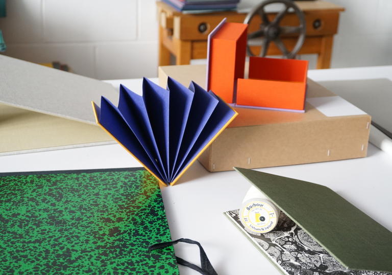 Detail of bookbinding workshop showing handmade notebook