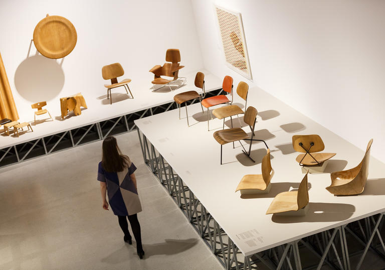 Woman walking through a room of chairs