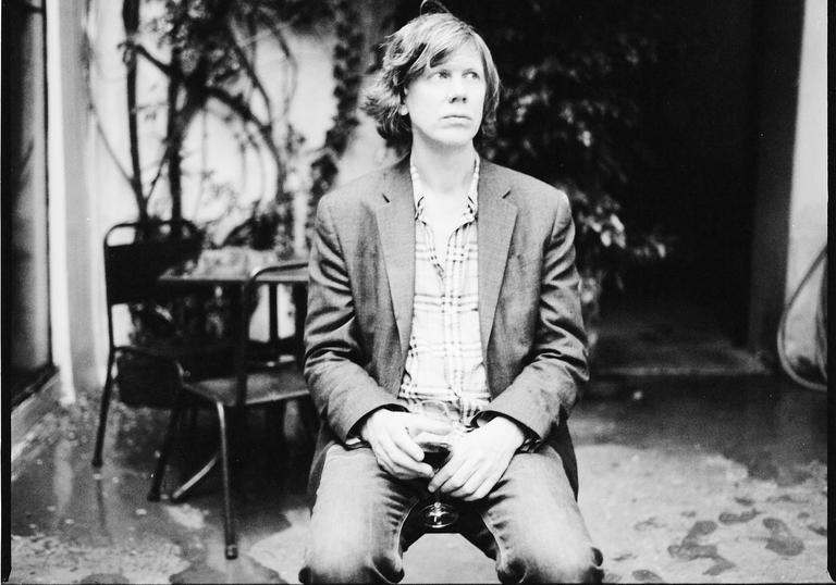 Thurston Moore enjoys a glass of red wine in the guardian whilst looking wistfully off into the distance