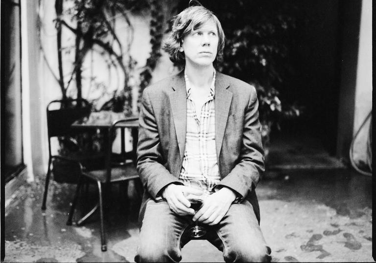 Thurston Moore enjoys a glass of red wine in the guardian whilst looking wistfully off into the distance