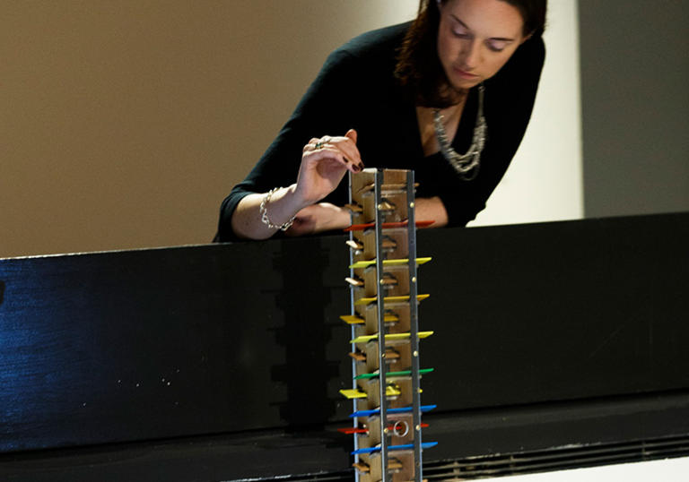 Woman playing with a musical tower