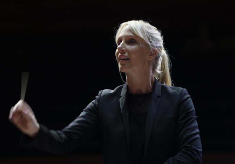 Sofi Jeannin conducting black background