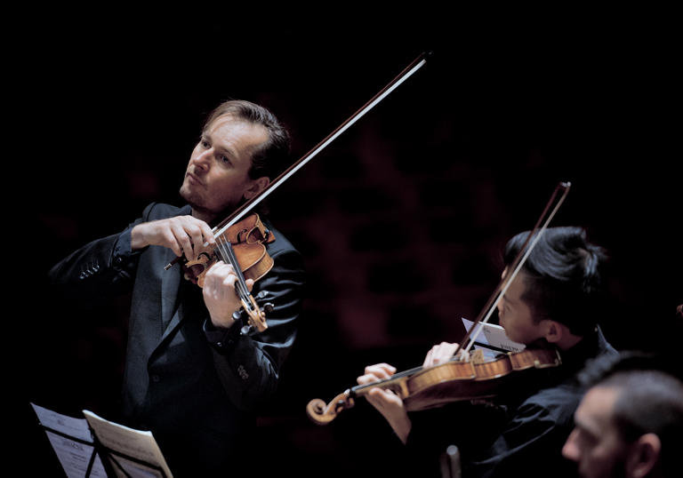 ACO and Tognetti performing on stage