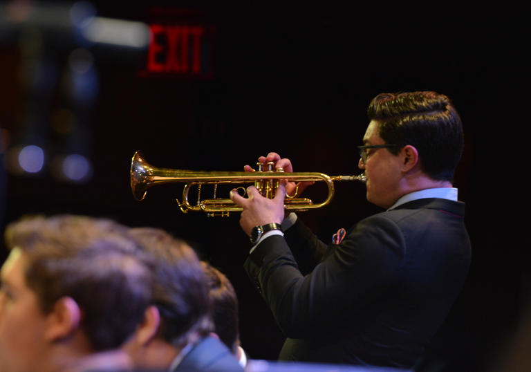 A young Jazz man playing a trumpet