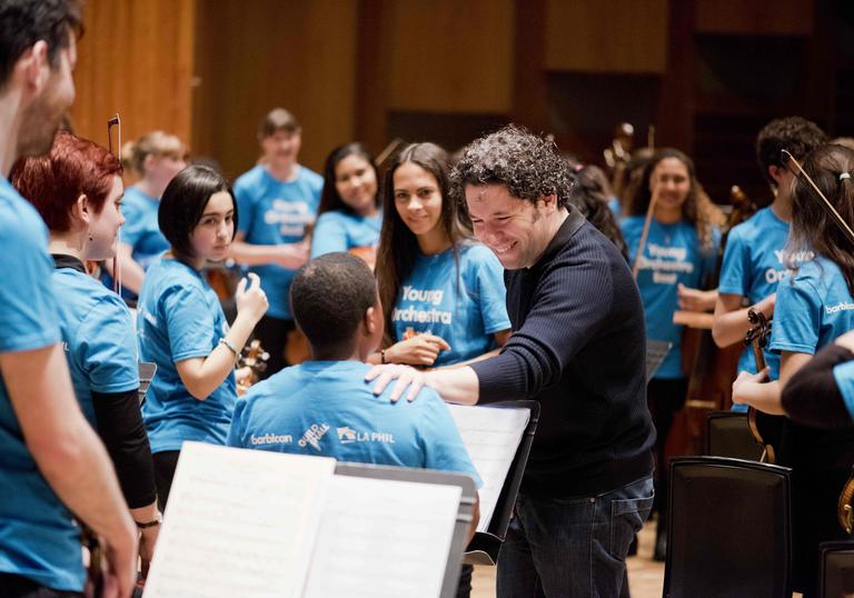 Gustavo Dudamel with young musicians from the Young Orchestra East