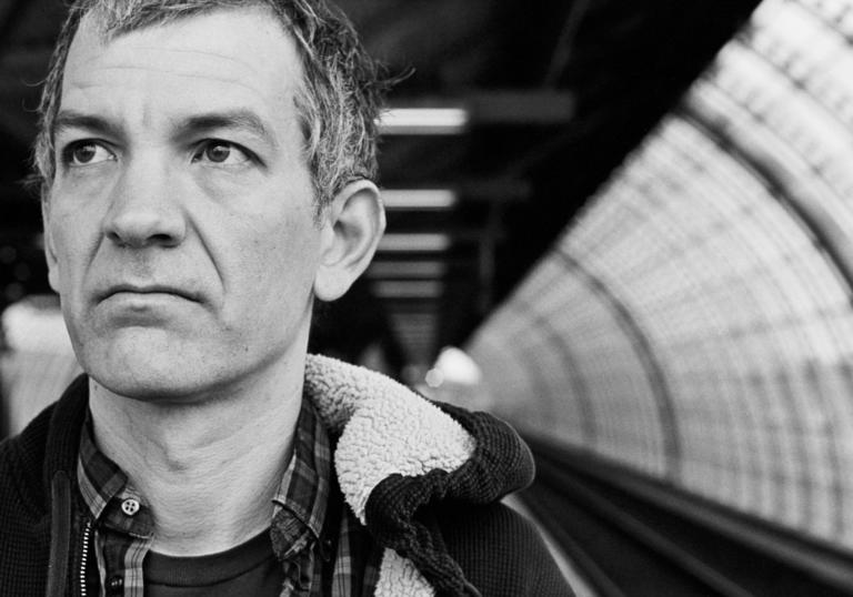 Brad Mehldau waiting for a train in black and white