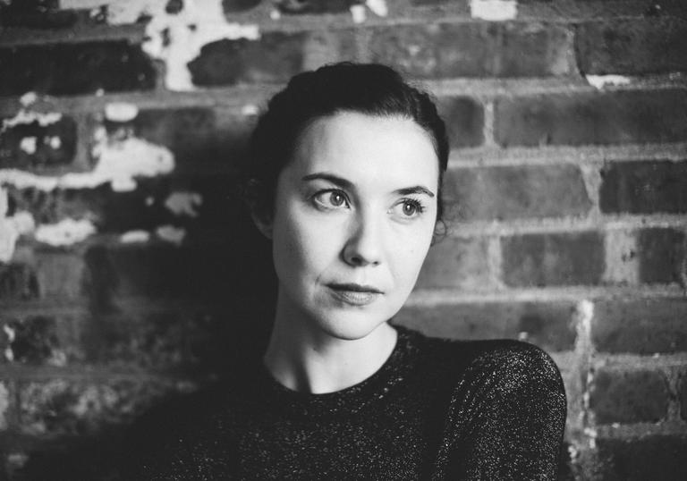 Lisa Hannigan standing in front of a brick wall