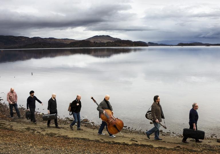 Transatlantic Session musicians walking along a loch