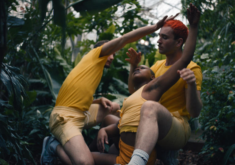 Three people in yellow dancing in Conservatory