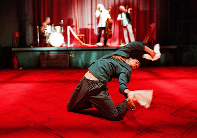 One dancer in front of a stage