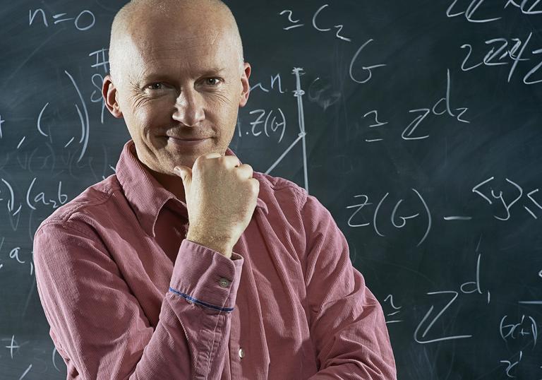 Marcus du Sautoy in front of a blackboard