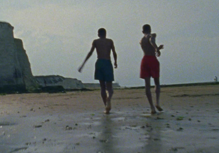 Two boys walking on a beach