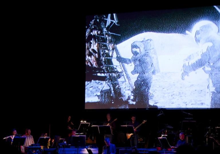 Icebreaker performing in front of footage from the Apollo moon landing