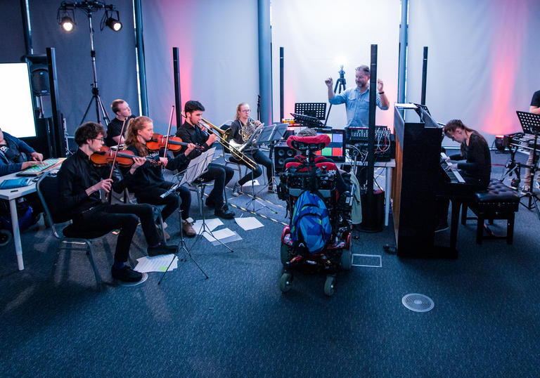 Young musicians who are disabled and able bodied play a selection of instruments as part of the National open Youth Orchestra