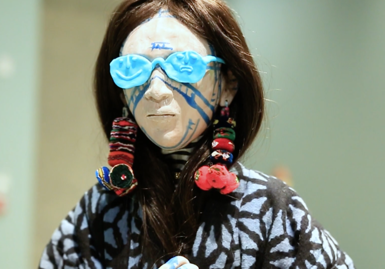 photo of sculpture of woman with blue sunglasses