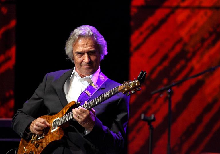 John McLaughlin playing guitar