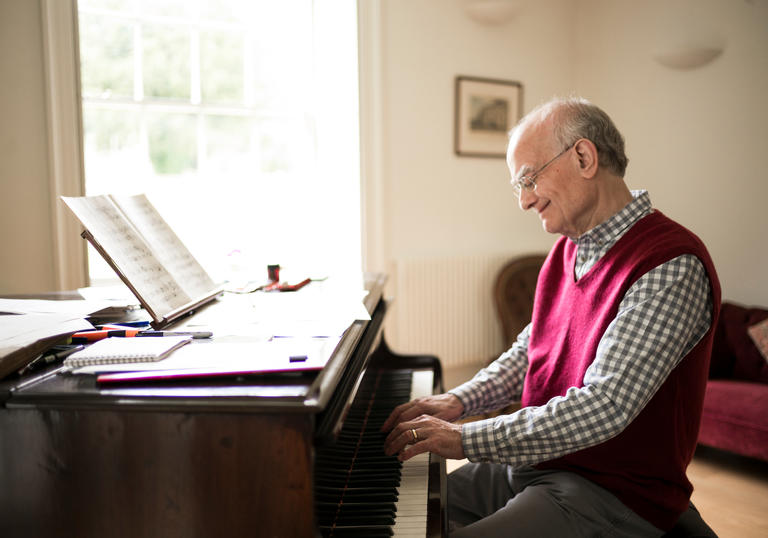 John Rutter sat at piano