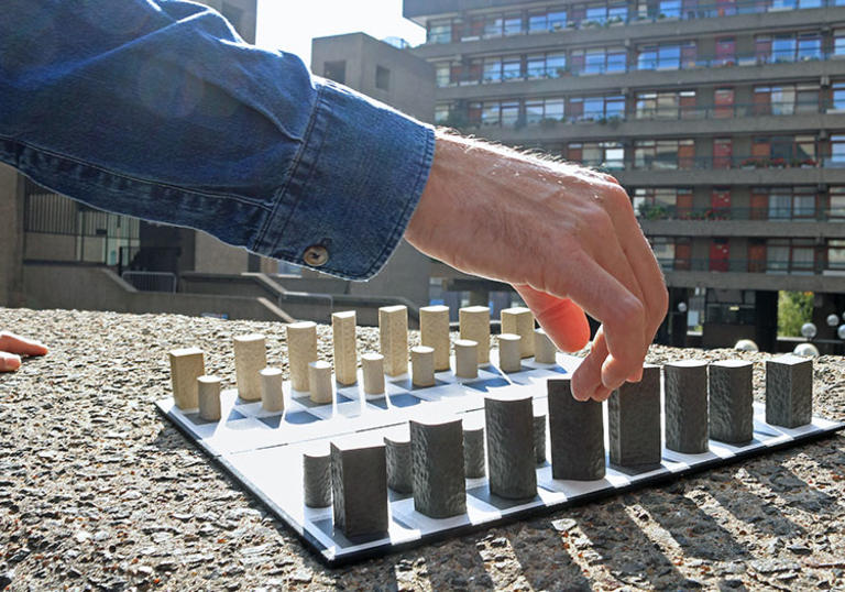 Hand and chess board 