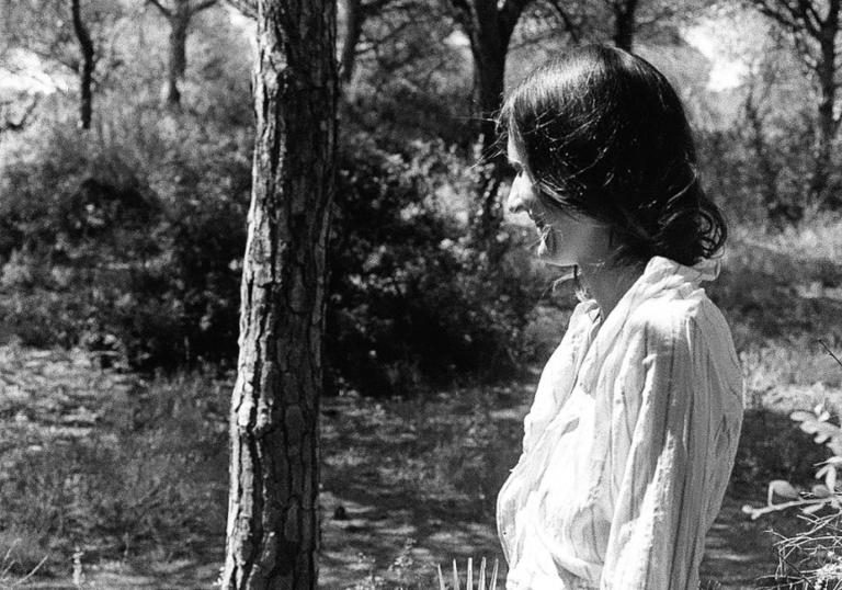 Josephine Foster standing in a wooded area