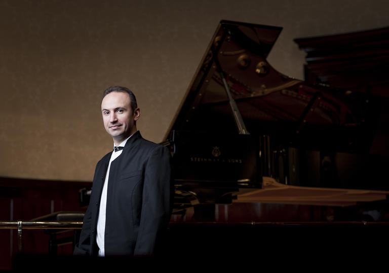 Simon Trpceski standing near piano